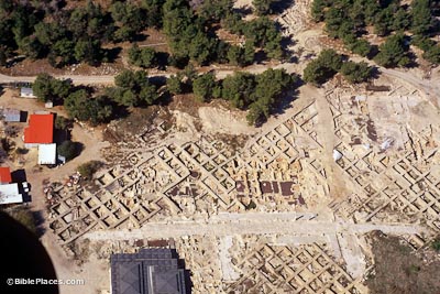 View from airplane of a dirt area with archaeological excavations forming a grid pattern